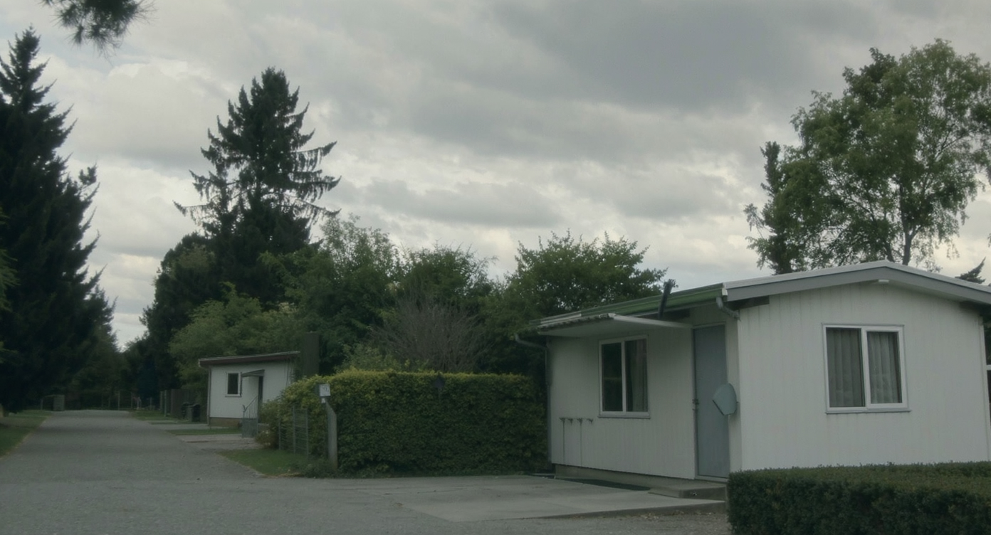 A modern modular home in a quiet neighborhood under a soft, overcast sky.